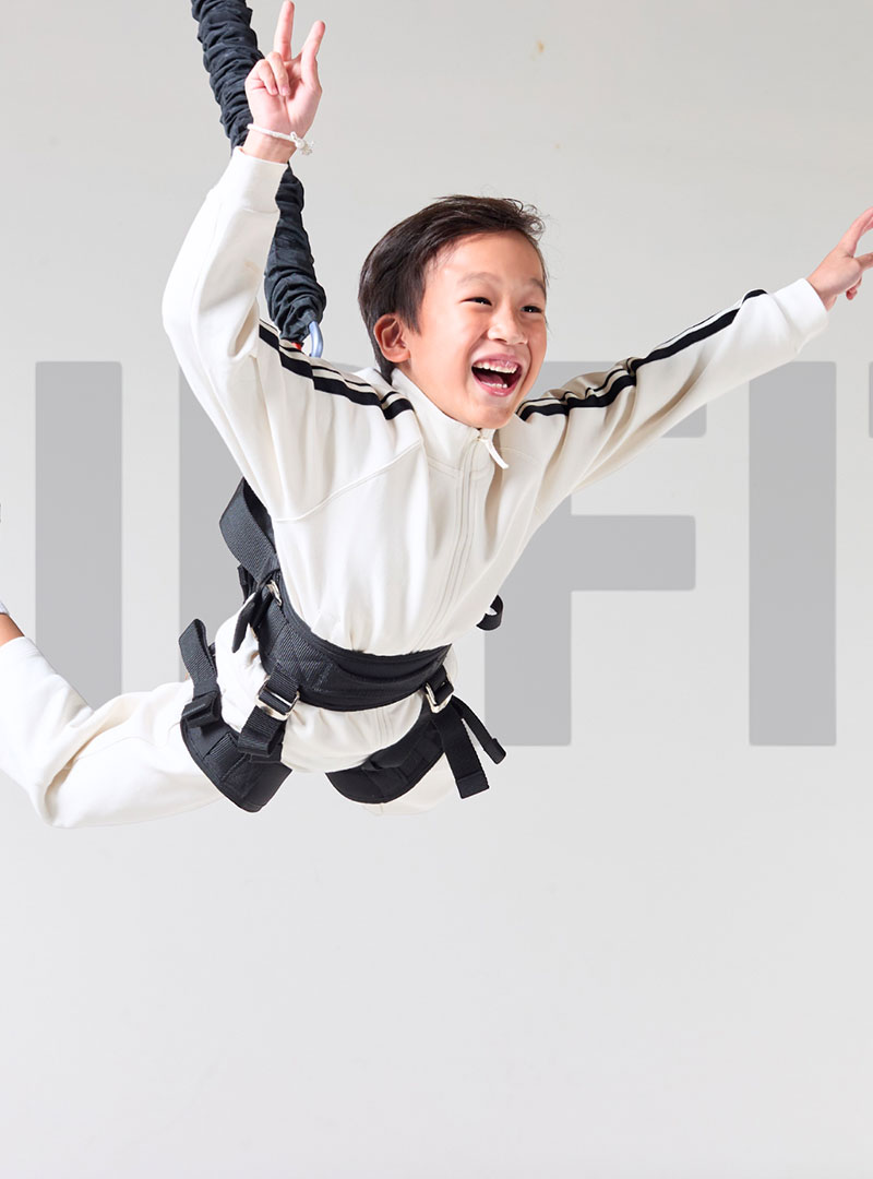 Kid performing fun bungee fitness workout using AIRFIT suspension training system