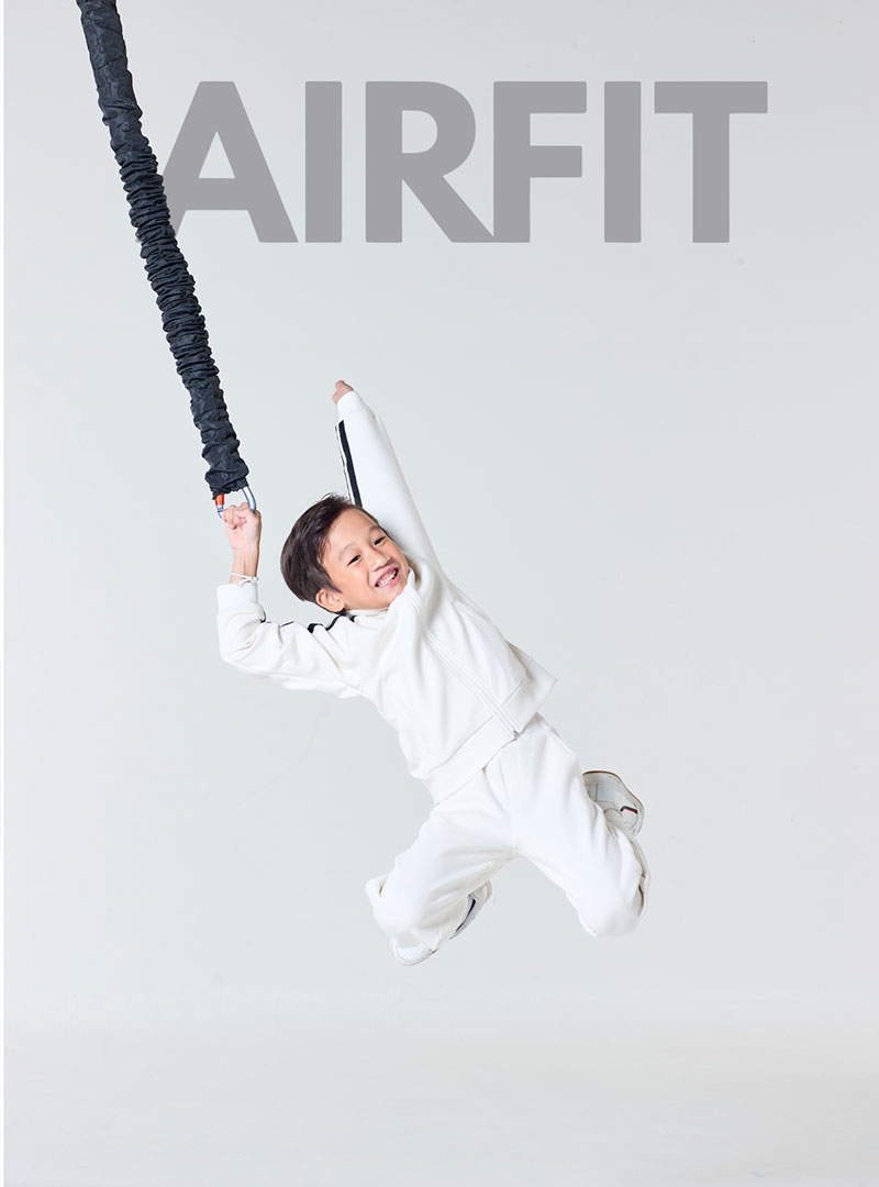 Kid performing fun bungee fitness workout using AIRFIT suspension training system