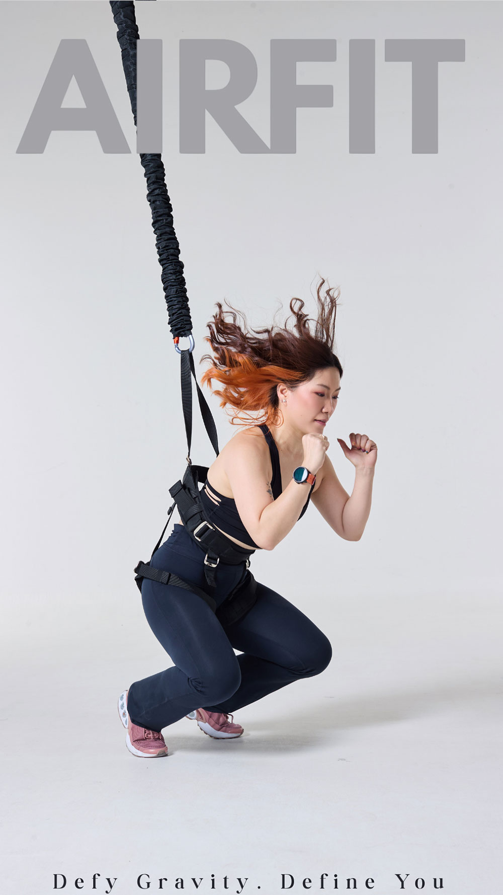 Instructor performing bungee fitness exercise during professional on site training program
