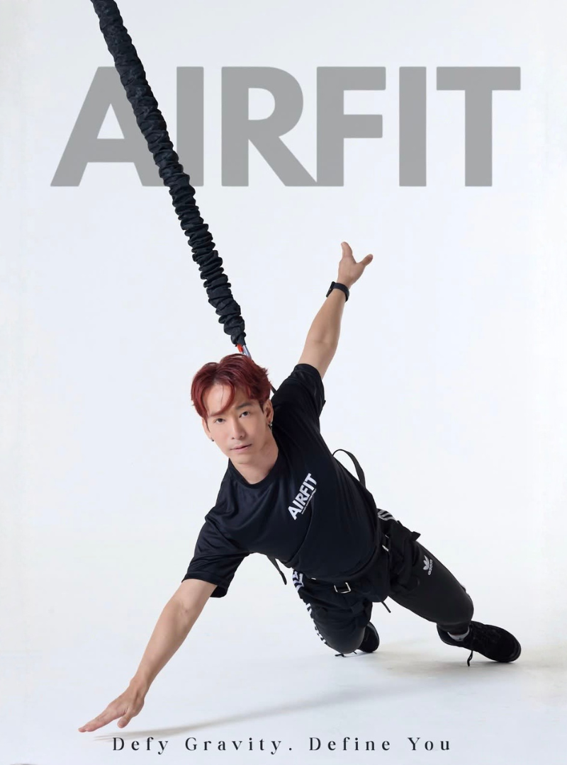Professional AIRFIT instructor demonstrating bungee fitness suspension training movement